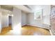 Open living area with brick wall, window, hardwood floors and ample natural light at 108 W Byers Pl # G4, Denver, CO 80223