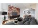 Cozy living room featuring exposed brick wall, hardwood floors and an open concept dining area at 108 W Byers Pl # G4, Denver, CO 80223