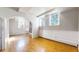 Bright living area features hardwood floors, brick wall, and ample natural light at 108 W Byers Pl # G4, Denver, CO 80223