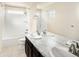 Bathroom featuring a double vanity with a large mirror, tile floor, and shower/tub combination at 10465 Evansville Cir, Parker, CO 80134
