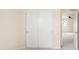 Bright bedroom featuring closet with sliding panel doors and neutral carpeting at 10465 Evansville Cir, Parker, CO 80134
