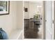 Open hallway to the living room with dark hardwood floors and bright interior at 10465 Evansville Cir, Parker, CO 80134