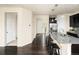 Open kitchen area with a granite island, bar stool seating, and hardwood floors at 10465 Evansville Cir, Parker, CO 80134