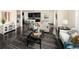 Open-concept living room featuring hardwood floors and a view of the kitchen at 10465 Evansville Cir, Parker, CO 80134