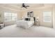 Spacious main bedroom featuring large windows, tray ceiling, and plush carpeting at 10465 Evansville Cir, Parker, CO 80134