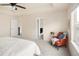 Bright main bedroom featuring a tray ceiling, sitting area, and ensuite bathroom with walk-in closet at 10465 Evansville Cir, Parker, CO 80134