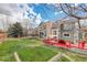 Expansive backyard with a red deck, lush lawn, and a charming swing set, perfect for outdoor relaxation and entertainment at 10059 Granite Hill Dr, Parker, CO 80134