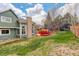 Spacious backyard featuring a well-maintained lawn, ideal for outdoor activities and relaxation, with deck and mature tree at 10059 Granite Hill Dr, Parker, CO 80134