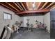 Unfinished basement with exposed beams that holds gym equipment and workout machines at 10059 Granite Hill Dr, Parker, CO 80134