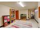 Finished basement area with speckled floors and recessed lighting; features bookshelf and aquarium at 10059 Granite Hill Dr, Parker, CO 80134
