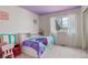 Cozy bedroom featuring a whimsical purple ceiling, large window, and playful decor at 10059 Granite Hill Dr, Parker, CO 80134