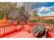 Large red-painted deck features a grill, hammock, play area and plenty of space to relax at 10059 Granite Hill Dr, Parker, CO 80134