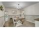 Dining room with wainscotting, chandelier and a table set for a meal at 10059 Granite Hill Dr, Parker, CO 80134