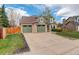 Charming two-story home with three car garage, lush lawn, and well-maintained landscaping at 10059 Granite Hill Dr, Parker, CO 80134