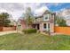 Inviting curb appeal with lush front lawn, mature landscaping, and charming brick and siding facade at 10059 Granite Hill Dr, Parker, CO 80134