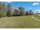 Expansive green space with lush grass, mature trees, and a paved path, creating a serene and inviting outdoor environment at 10059 Granite Hill Dr, Parker, CO 80134