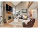 Spacious living room featuring a vaulted ceiling, brick fireplace, and comfortable seating area at 10059 Granite Hill Dr, Parker, CO 80134