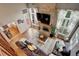Open-concept living room with brick fireplace, abundant natural light and adjacent dining area at 10059 Granite Hill Dr, Parker, CO 80134