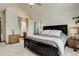 Comfortable bedroom features a dark wood frame bed, ensuite bathroom, and vaulted ceilings at 10059 Granite Hill Dr, Parker, CO 80134