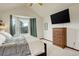 Bright main bedroom with neutral carpet, bay window and television at 10059 Granite Hill Dr, Parker, CO 80134