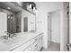 Stylish bathroom with double sinks, modern lighting, and a glass-enclosed shower at 2676 W 68Th Ave, Denver, CO 80221