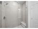 Glass enclosed shower with tiled surround and built-in bench seating at 2676 W 68Th Ave, Denver, CO 80221