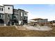 Exterior of modern townhomes showcasing a community patio and seating area at 2676 W 68Th Ave, Denver, CO 80221