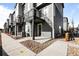 Modern townhome exterior with black accents, landscaping, and private balconies at 2676 W 68Th Ave, Denver, CO 80221