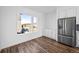 Kitchen area with stainless steel refrigerator, cabinetry and a view from the window at 2676 W 68Th Ave, Denver, CO 80221