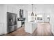 Modern kitchen featuring white cabinets, stainless steel appliances, and an island at 2676 W 68Th Ave, Denver, CO 80221