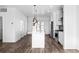 Open kitchen featuring a central island with pendant lights and stainless steel appliances at 2676 W 68Th Ave, Denver, CO 80221