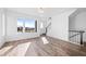 Open-concept living room with modern staircase and hardwood flooring at 2676 W 68Th Ave, Denver, CO 80221