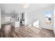 Bright open-concept living space featuring a kitchen island, stainless appliances, and light wood flooring at 2676 W 68Th Ave, Denver, CO 80221