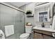 A bathroom featuring a glass shower, modern fixtures, and contemporary decor at 8721 W 86Th Ave, Arvada, CO 80005