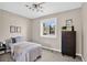 This comfortable bedroom has a large window, closet space and modern lighting at 8721 W 86Th Ave, Arvada, CO 80005