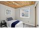 A cozy bedroom with a wood ceiling, a patterned rug, and a comfortable bed at 8721 W 86Th Ave, Arvada, CO 80005