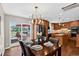 An open dining room with seating for four, a view of the deck, and the kitchen in the background at 8721 W 86Th Ave, Arvada, CO 80005
