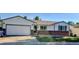Charming single-story home with a brick accent, a two car garage, and a well-maintained lawn at 8721 W 86Th Ave, Arvada, CO 80005