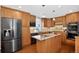 A spacious kitchen with stainless steel appliances, wood cabinets, and a center island at 8721 W 86Th Ave, Arvada, CO 80005