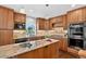 Beautiful kitchen with custom cabinets, granite counters, stainless appliances, and wood floors at 8721 W 86Th Ave, Arvada, CO 80005