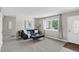 Bright and spacious living room featuring a cozy couch, neutral tones, and ample natural light at 8721 W 86Th Ave, Arvada, CO 80005
