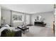Bright living room with gray walls, carpet flooring, a large window, and a view of the front entrance at 8721 W 86Th Ave, Arvada, CO 80005