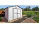 Well-maintained storage shed with double doors and a charming, functional design in backyard at 8721 W 86Th Ave, Arvada, CO 80005