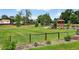 Scenic view of the community park, with green grass, a playground, and mature trees from the property at 8721 W 86Th Ave, Arvada, CO 80005