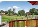 Scenic view from the back deck of the community park, with green grass, a playground, and mature trees at 8721 W 86Th Ave, Arvada, CO 80005