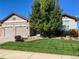 Beautiful two-story home with a landscaped lawn and two-car garage at 15735 Carob Cir, Parker, CO 80134