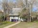 Charming single story home with mature trees, a gravel roof, and a welcoming entrance at 857 S Leyden St, Denver, CO 80224