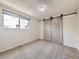 Neutral bedroom featuring sliding barn doors, carpet, and a light fixture at 5300 E Cherry Creek South Dr # 620, Denver, CO 80246