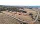 Aerial view of house and surrounding land, roads, and trees at 7076 Inspiration Dr, Parker, CO 80138