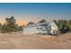 Detached barn with large metal doors and surrounding trees at 7076 Inspiration Dr, Parker, CO 80138